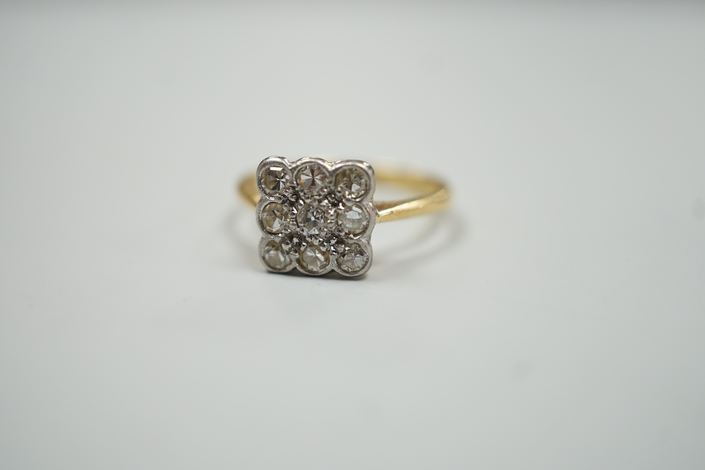 An 18ct and collet set nine stone diamond cluster table ring, size K/L, gross weight 2.6 grams. - Image 2 of 4