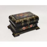 A Victorian painted and mother of pearl inlaid papier mache tea caddy. 23cm wide