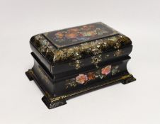 A Victorian painted and mother of pearl inlaid papier mache tea caddy. 23cm wide