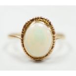 A yellow metal and oval white opal set ring, size Q, gross weight 2 grams.