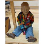 An unusual vintage shop dummy of a seated young boy, 53cm