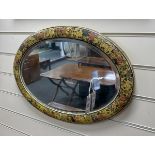 An Indian painted oval wall mirror, width 54cm, height 38cm