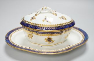 An 18th century Caughley tureen cover and stand with blue and gilt decoration, stand mis-fired to
