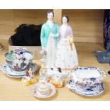 A pair of Staffordshire porcellaneous groups of children with a King Charles spaniel and a figure of
