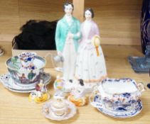 A pair of Staffordshire porcellaneous groups of children with a King Charles spaniel and a figure of