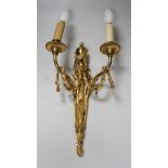 An ornate Louis XVI style gilt metal two branch wall sconce, 48 cm high including bulbs