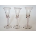 A trio of George III style cotton twist stemmed glasses, 17.5cms high