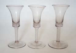A trio of George III style cotton twist stemmed glasses, 17.5cms high