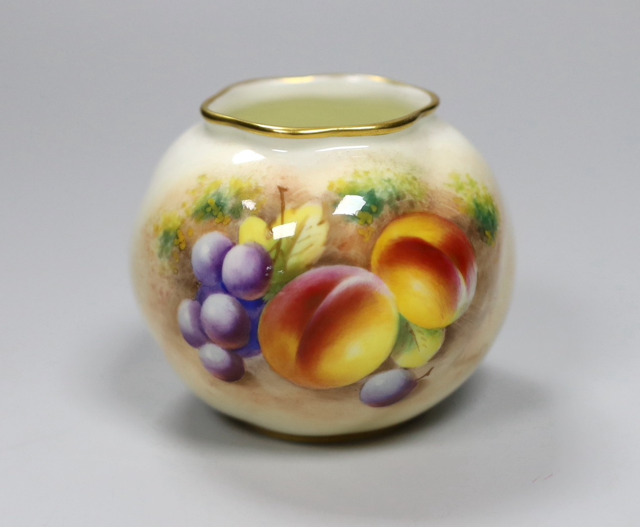 A Royal Worcester spirally moulded globular vase painted with fruits by Roberts, date code for 1955,
