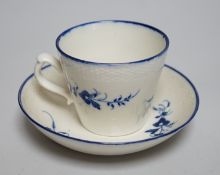 An 18th century Caughley coffee cup and saucer, Chantilly sprigs under a basket weave moulded