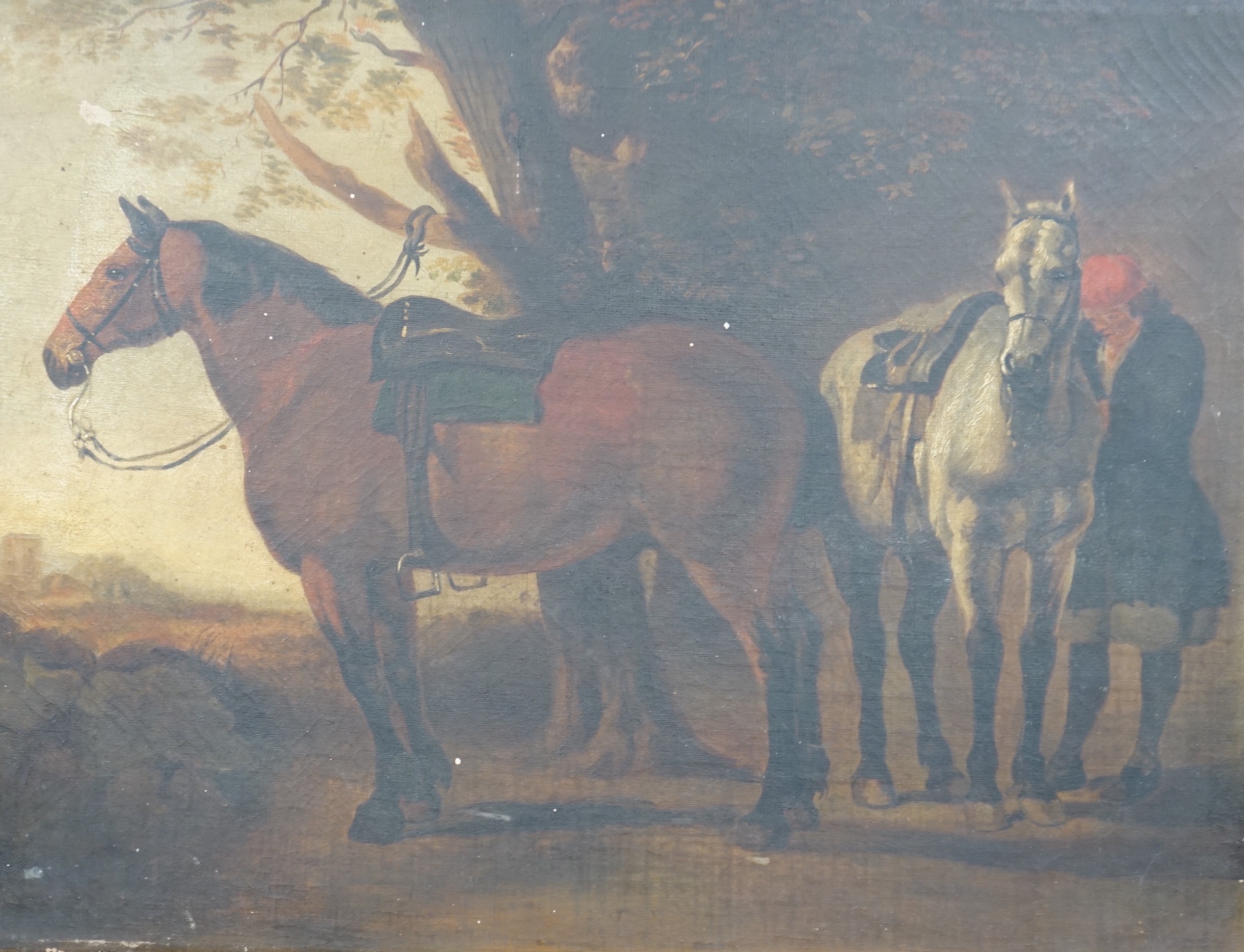 19th century English School, oil on canvas, Groom attending two horses, 30 x 41cm, unframed