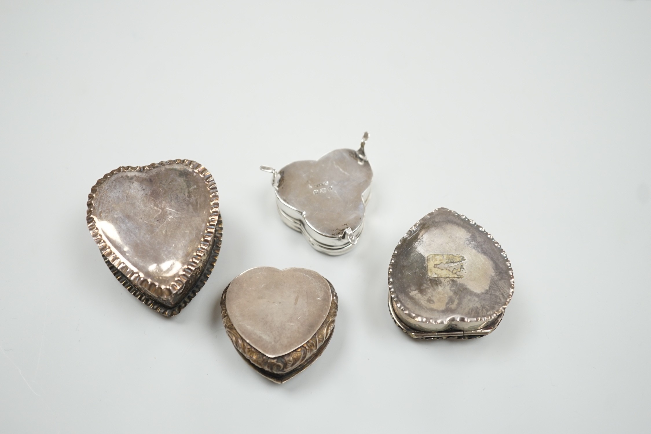 Three Victorian/Edwardian repousse silver heart shaped trinket boxes, largest 56mm and a similar - Image 3 of 4