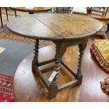 A Carolean style oak drop flap occasional table on spiral turned under frame width 69cm extended,
