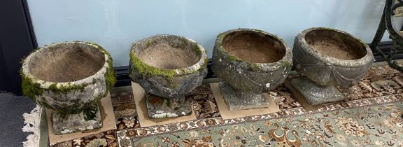 Two pairs of circular reconstituted stone garden planters, larger diameter 39cm, height 33cm