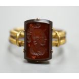 A 19th century yellow metal overlaid and rectangular intaglio chalcedony set ring, the matrix carved