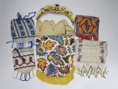 A 19th century ornately multicoloured beaded bag with a bead fringe, two smaller similar beaded