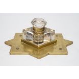 A Victorian brass mounted glass inkwell. 24cm wide