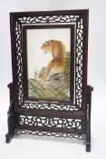 A Chinese reversible silk embroidered panel of a tiger in a revolving screen and hardwood carved