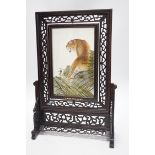 A Chinese reversible silk embroidered panel of a tiger in a revolving screen and hardwood carved