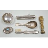 A late Victorian silver caddy spoon, 92mm, a silver cigarette holder, toothbrush, two trinket