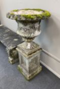 A reconstituted stone campana garden urn on square plinth, diameter 51cm, height 101cm