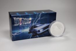 A Back to the Future DeLorean silver coin and model car set and an Australia mint 10oz bullion