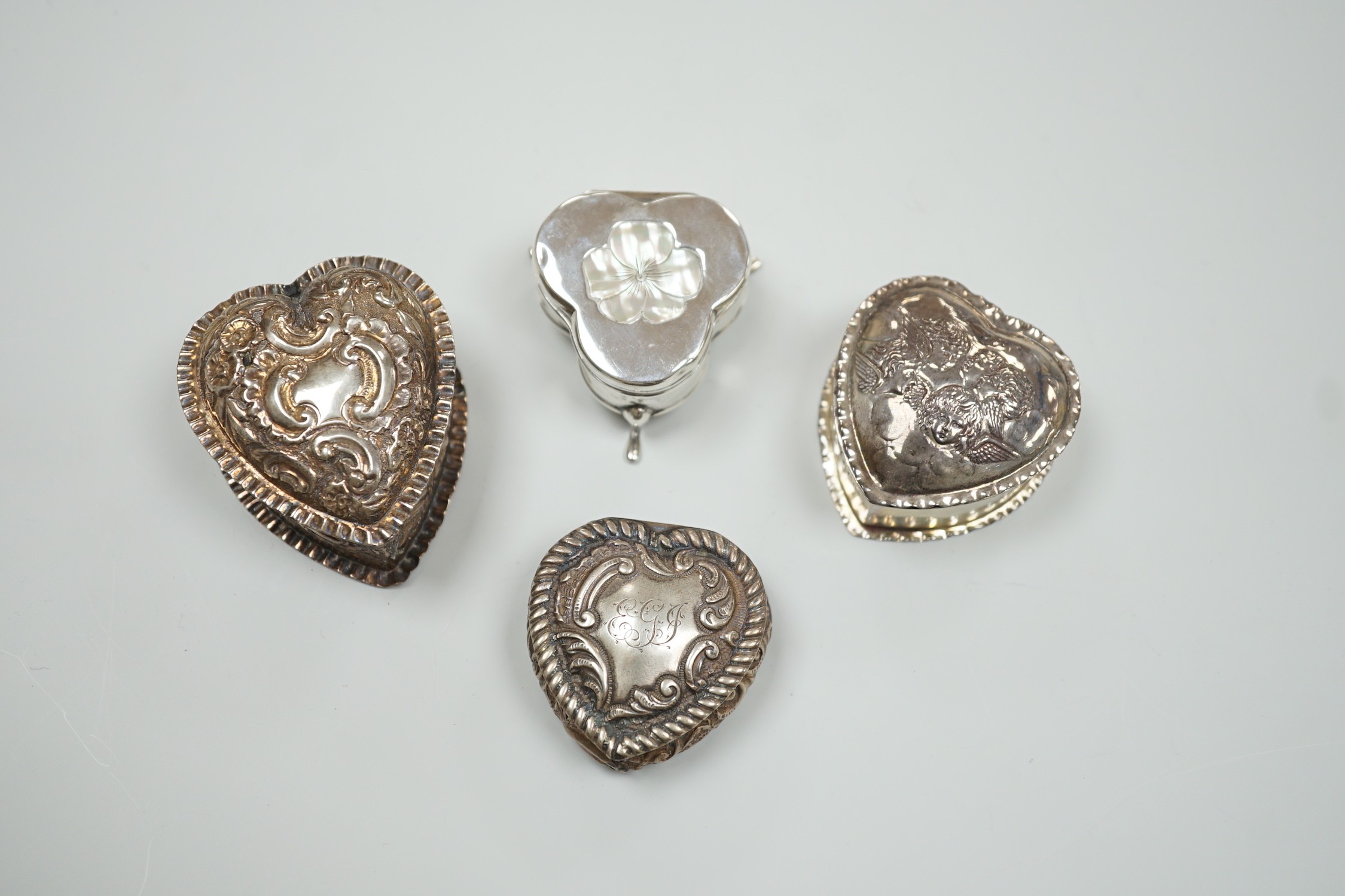 Three Victorian/Edwardian repousse silver heart shaped trinket boxes, largest 56mm and a similar - Image 2 of 4