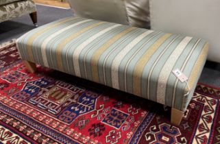 A contemporary rectangular footstool upholstered in Kravet stripe fabric width 117cm, depth 56cm,