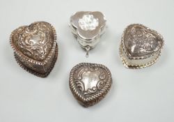 Three Victorian/Edwardian repousse silver heart shaped trinket boxes, largest 56mm and a similar