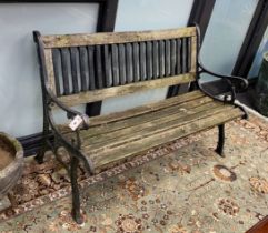 A cast iron slatted wood garden bench, length 126cm, depth 60cm, height 82cm