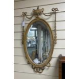 An Edwardian Adam-design oval giltwood and composition wall mirror, width 41cm, height 76cm