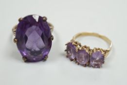 A modern 9ct gold and three stone amethyst set half hoop ring and a 9ct gold and synthetic colour