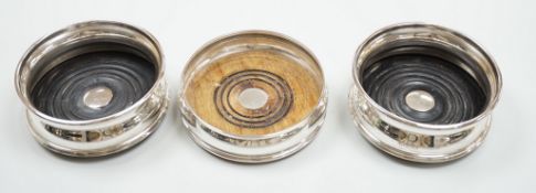 A pair of modern silver wine coasters, diameter 12.4cm and a single silver mounted wine coaster.