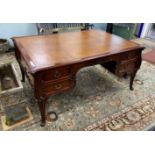 An early 20th century mahogany kneehole partner's desk with tooled tan leather inset top, length