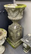 A reconstituted stone campana garden urn on lion mask plinth, diameter 60cm, height 130cm