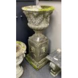 A reconstituted stone campana garden urn on lion mask plinth, diameter 60cm, height 130cm