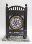 A Victorian Aesthetic Movement ebonised mantel clock in the manner of Walter Crane and Lewis Day.