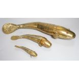 A set of three graduated brass articulated fish, largest 43.3cms long