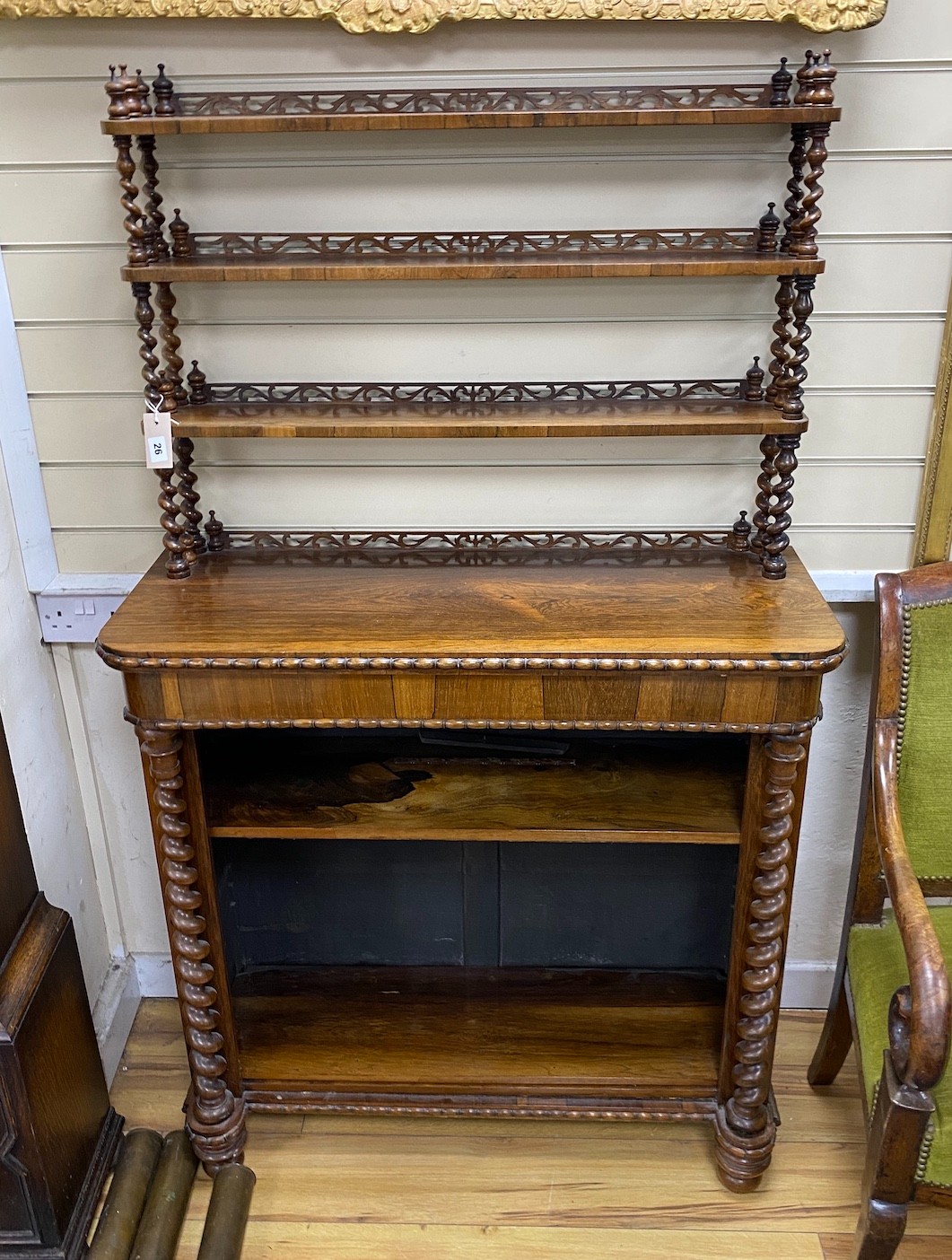 An early Victorian rosewood open bookcase with spiral turned fretwork superstructure, width 92cm,