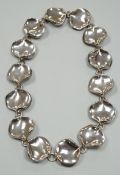 A modern Georg Jensen style silver necklace, with stylised petal links, maker AoL, London, 2008,