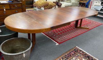 A mid century Danish design Indian rosewood extending dining table, 308cm extended, three spare