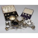 Assorted silver ware including two cased sets of six teaspoons, one with tongs, a christening mug,