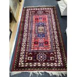 A Caucasian style red ground rug, 190 x 102cm