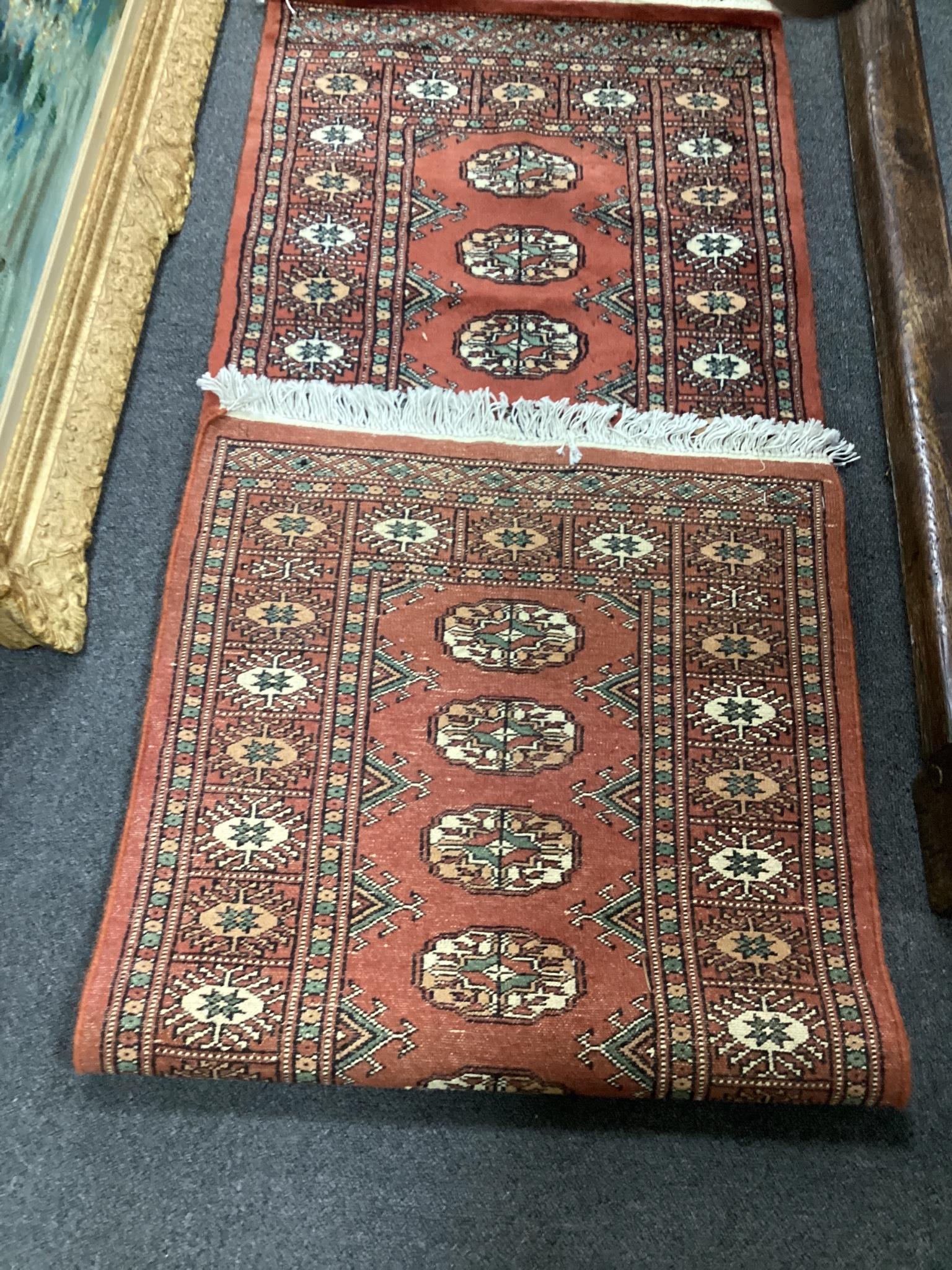 A Bokhara style red ground rug, 190 x 62cm - Image 2 of 3