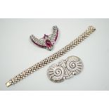 An Art Deco style white metal and two colour paste set curved clip brooch, a paste set double clip