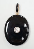 A Victorian yellow metal mounted black onyx oval locket, with black enamelled bale and set with an