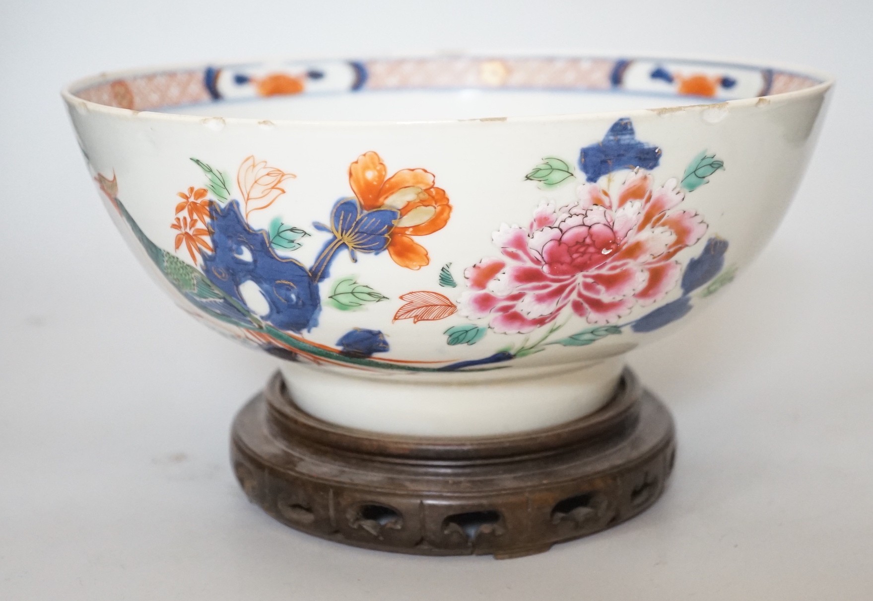 An 18th century Chinese famille rose bowl on wood stand, c.1740, diameter 26cm