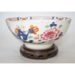 An 18th century Chinese famille rose bowl on wood stand, c.1740, diameter 26cm