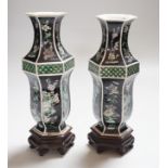 A pair of Chinese famille noire hexagonal vases, late 19th century, wood stands, 21cms high