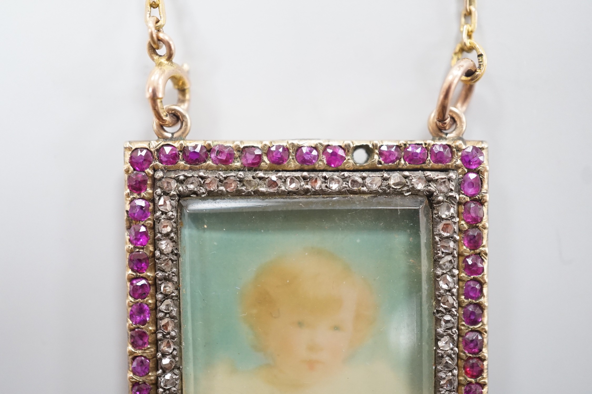 An early 20th century yellow metal, ruby and diamond mounted portrait pendant, 34mm (two rubies - Image 2 of 4